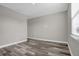 Simple bedroom with wood-look floors and a window at 1402 Persimmon Ave, Sanford, FL 32771