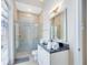 Bathroom with granite vanity, walk-in shower, and updated fixtures at 415 Muirfield Loop, Reunion, FL 34747