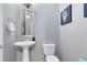 Small bathroom with pedestal sink and toilet at 415 Muirfield Loop, Reunion, FL 34747