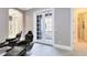 Game room with two black leather gaming chairs and access to balcony at 415 Muirfield Loop, Reunion, FL 34747