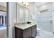 Bathroom with granite vanity and walk-in shower at 415 Muirfield Loop, Reunion, FL 34747