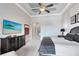 Large bedroom with king-size bed and a large TV at 415 Muirfield Loop, Reunion, FL 34747