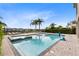 Relaxing pool area with spa and lounge chairs at 415 Muirfield Loop, Reunion, FL 34747