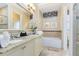 Elegant bathroom with granite countertops and a large soaking tub at 415 Muirfield Loop, Reunion, FL 34747