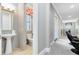 Small bathroom with pedestal sink and toilet at 415 Muirfield Loop, Reunion, FL 34747