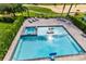 Luxury pool with spa and plenty of seating, overlooking a golf course at 415 Muirfield Loop, Reunion, FL 34747