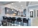 Modern kitchen with gray cabinets, granite counters, and stainless steel appliances at 415 Muirfield Loop, Reunion, FL 34747