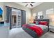 King-size bed, red accents and patio access at 415 Muirfield Loop, Reunion, FL 34747