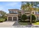Luxury home with two-car garage and manicured landscaping at 415 Muirfield Loop, Reunion, FL 34747