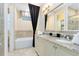 Bathroom with double vanity, soaking tub, and granite countertop at 415 Muirfield Loop, Reunion, FL 34747