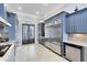 Modern kitchen with stainless steel appliances and gray cabinets at 415 Muirfield Loop, Reunion, FL 34747