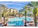 Resort-style pool with lounge chairs and palm trees at 12544 Floridays Resort Dr # 203-B, Orlando, FL 32821