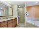 Bathroom with tub, shower, granite vanity and mirror at 12544 Floridays Resort Dr # 203-B, Orlando, FL 32821