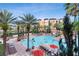 Large community pool with many people swimming at 12544 Floridays Resort Dr # 203-B, Orlando, FL 32821