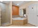 Bathroom with corner bathtub, shower, and view of bedroom at 12544 Floridays Resort Dr # 203-B, Orlando, FL 32821