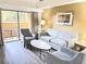 Bright living room with comfy seating, a coffee table, and access to a balcony at 12544 Floridays Resort Dr # 203-B, Orlando, FL 32821
