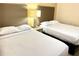 Bedroom with two double beds and nightstand at 12544 Floridays Resort Dr # 203-B, Orlando, FL 32821