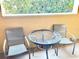 Small balcony with table and chairs, perfect for relaxing outdoors at 12544 Floridays Resort Dr # 203-B, Orlando, FL 32821