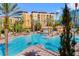 Resort-style pool with lounge chairs and building view at 12544 Floridays Resort Dr # 203-B, Orlando, FL 32821