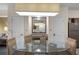 Dining area with glass table, four chairs, and a view of the kitchen at 12544 Floridays Resort Dr # 203-B, Orlando, FL 32821