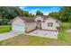 Single-story home with a two-car garage and landscaped yard at 17279 Peggy Ave, Mount Dora, FL 32757