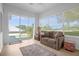Relaxing sunroom with comfy couch and view of the backyard at 21242 Braveheart Dr, Leesburg, FL 34748