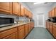Well-equipped kitchen with wood cabinets and granite counters at 21242 Braveheart Dr, Leesburg, FL 34748