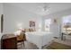 Bright bedroom with a king-size bed and ceiling fan at 21242 Braveheart Dr, Leesburg, FL 34748
