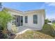 Private patio with yellow chair and view of green space at 21242 Braveheart Dr, Leesburg, FL 34748