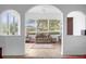 Sunroom with arched entry and a view of the golf course at 21242 Braveheart Dr, Leesburg, FL 34748