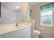 Clean bathroom with single sink vanity and toilet at 21242 Braveheart Dr, Leesburg, FL 34748