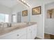 Bathroom with double vanity and large mirror at 21242 Braveheart Dr, Leesburg, FL 34748