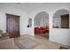 Living room with red couches and a view into the kitchen at 21242 Braveheart Dr, Leesburg, FL 34748