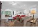 Spacious living room with comfortable seating and a view to kitchen at 21242 Braveheart Dr, Leesburg, FL 34748