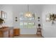 Dining area with plantation shutters and a chandelier at 21242 Braveheart Dr, Leesburg, FL 34748