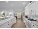 Well-equipped kitchen with white cabinets and stainless steel appliances at 21242 Braveheart Dr, Leesburg, FL 34748