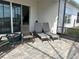 Relaxing patio with lounge chairs and a small table at 1753 Flora Pass Pl, Kissimmee, FL 34747