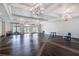 Large community room with hardwood floors and chandelier at 1753 Flora Pass Pl, Kissimmee, FL 34747