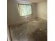 Empty bedroom with a large window and new flooring at 525 Conway Rd # 201, Orlando, FL 32807