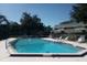 Community pool with surrounding lounge chairs at 525 Conway Rd # 201, Orlando, FL 32807