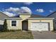 One-story house with a two-car garage and landscaped lawn at 2651 Bittern Bnd, Saint Cloud, FL 34771