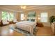 Spacious primary bedroom with wood floors and large windows at 276 Tavestock Loop, Winter Springs, FL 32708
