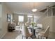Bright dining room features a glass-top table and seating for four at 276 Tavestock Loop, Winter Springs, FL 32708