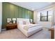 Main bedroom with green accent wall and plush bed at 5887 High Seas Dr, Orlando, FL 32821