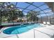 Screened-in pool and spa with lounge chairs at 5887 High Seas Dr, Orlando, FL 32821