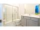 Modern bathroom with gray vanity, walk-in shower, and tile floor at 5887 High Seas Dr, Orlando, FL 32821