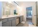 Modern bathroom with double vanity and gray cabinets at 5887 High Seas Dr, Orlando, FL 32821
