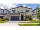 Two-story modern home with attached garage and landscaping at 5887 High Seas Dr, Orlando, FL 32821