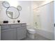 Bathroom with gray vanity, white tub and Mickey Mouse decor at 5887 High Seas Dr, Orlando, FL 32821