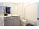 Simple bathroom with tub, toilet and gray vanity at 5887 High Seas Dr, Orlando, FL 32821